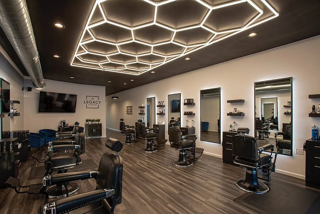 Barber shop interior with chairs and mirrors, modern ceiling design.
