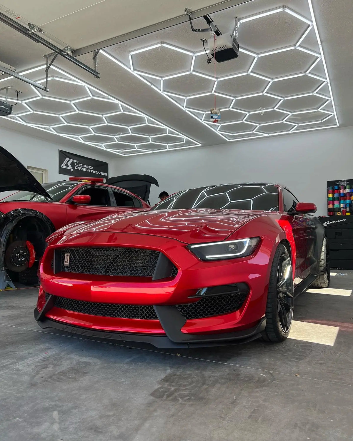 Red Mustang with Hexagon Lighting. Car Wrapping Garage. 