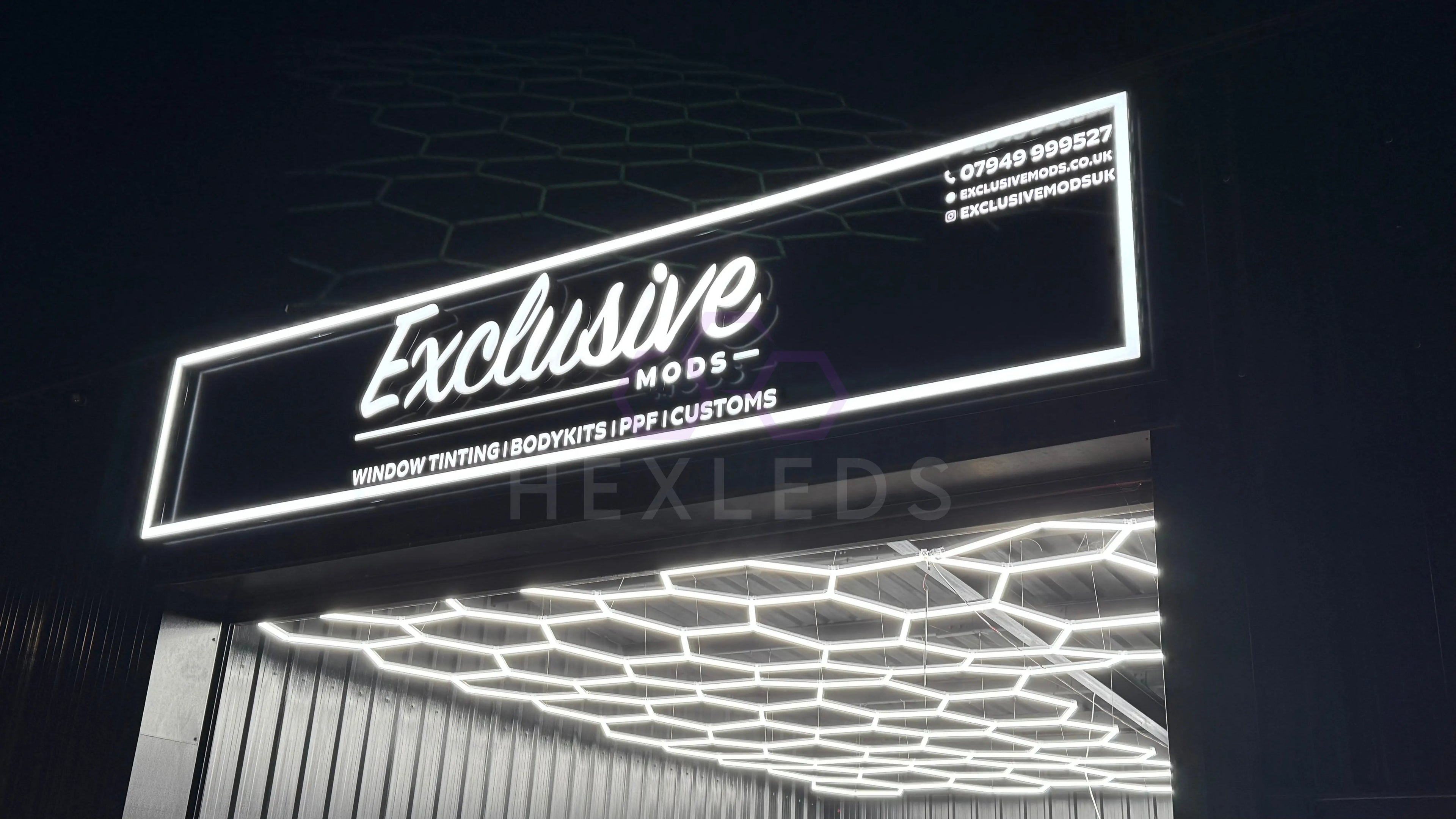 Car styling shop using hexagon lights with outdoor lit up sign