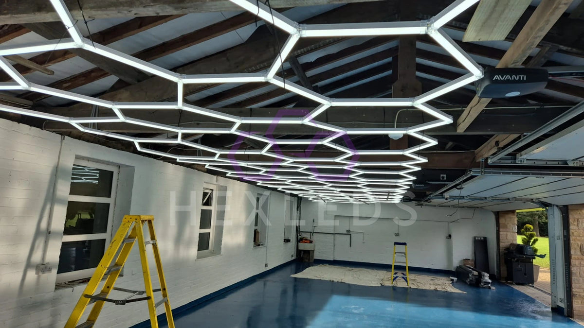 Modern ceiling design with hexagon light fixture in a room with a pool.