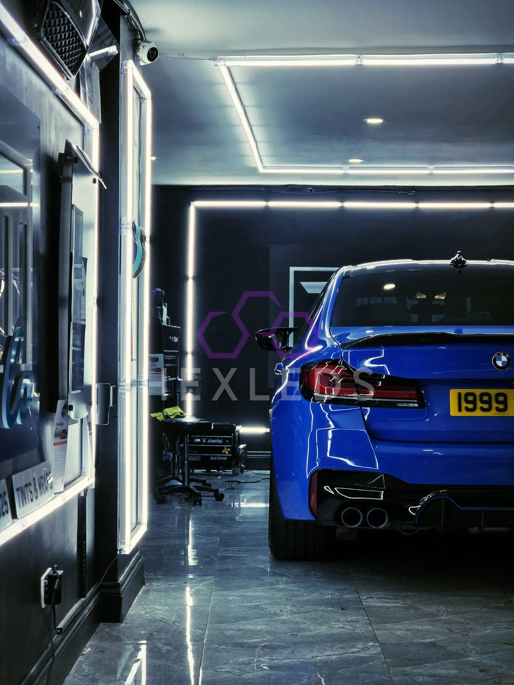 Blue BMW car inside a showroom with a modern interior.